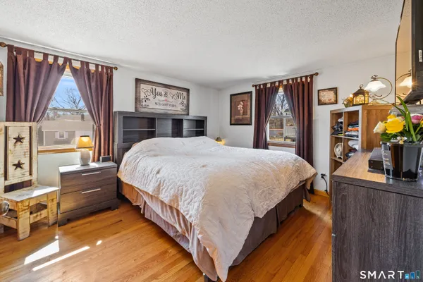 a bed sitting in a bedroom next to a window