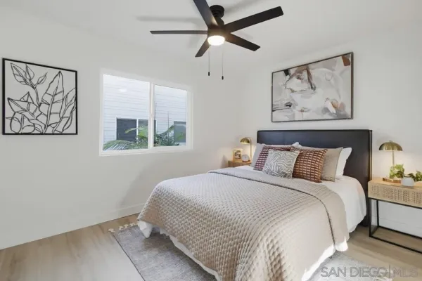 a bedroom with a large bed and a window