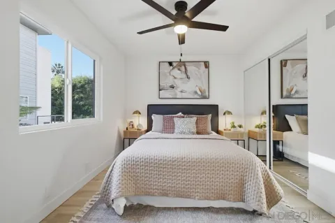 a bedroom with a large bed and a window