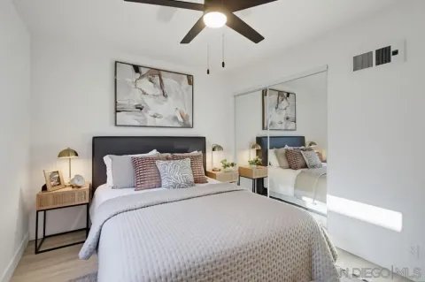 a bedroom with bed and wall painting