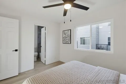 a bedroom with a bed and a window