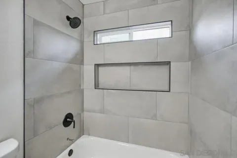a bathroom with a bathtub and shower