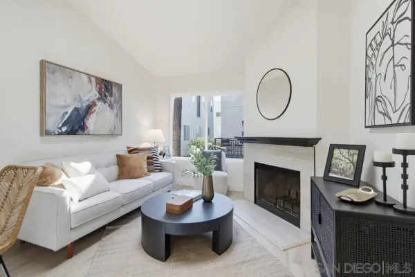 a living room with furniture a fireplace and a wall painting