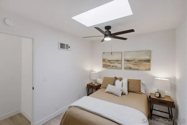 a bedroom with a bed and a ceiling fan