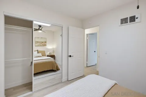 a bedroom with a bed and a mirror