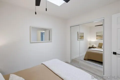 a bedroom with a bed and a lamp