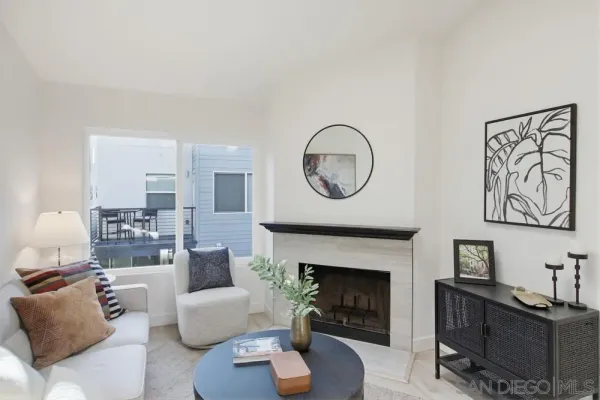 a living room with furniture a fireplace and a large mirror