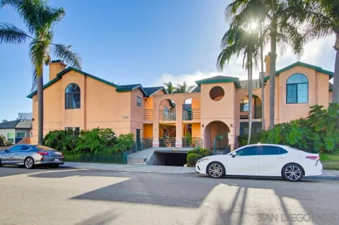 a couple of cars parked in front of a house