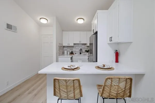 a kitchen with a table and chairs in it