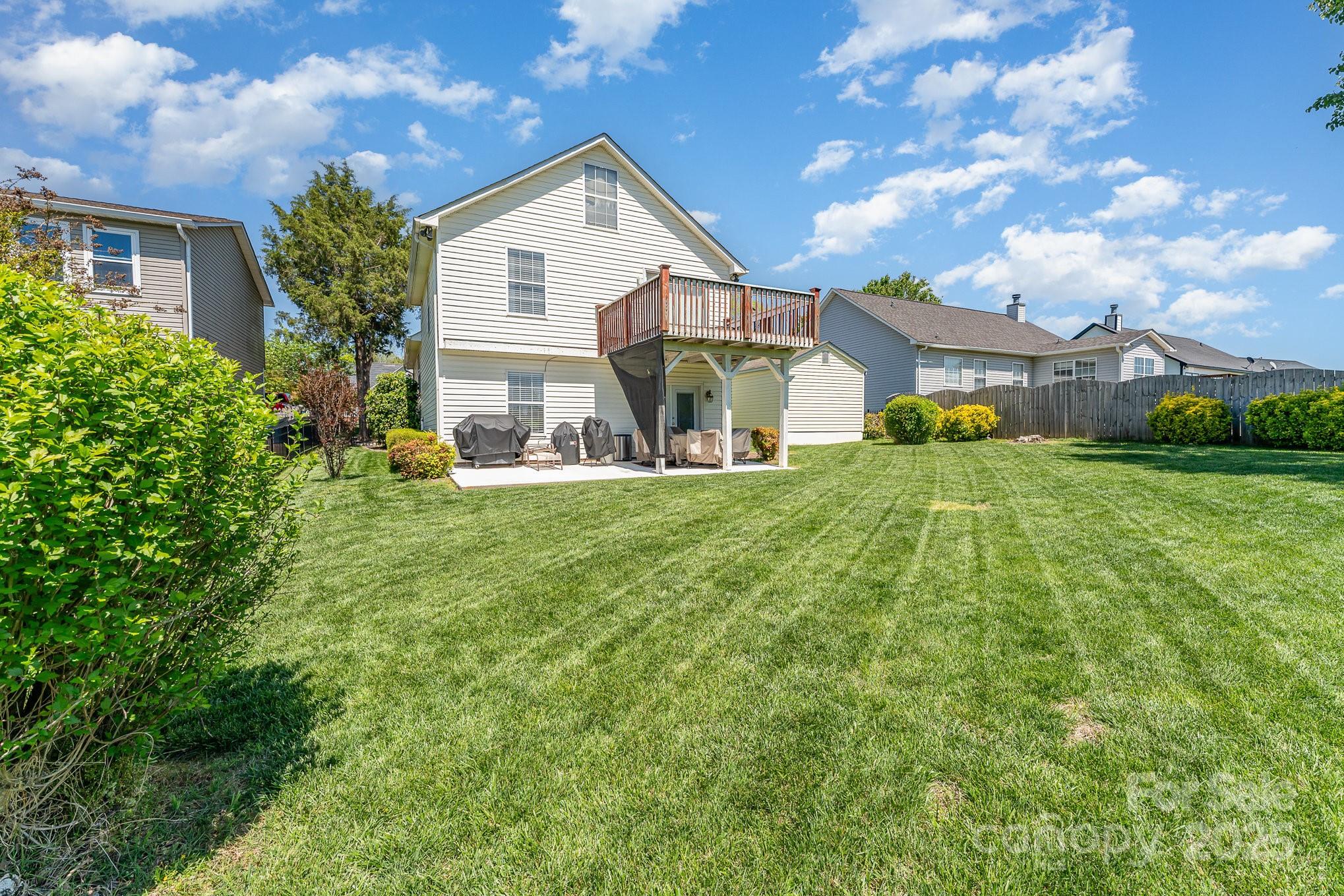 1076 Braxton Drive Concord, NC 28025 - Photo 18 of 20 a view of a house with a big yard and large trees