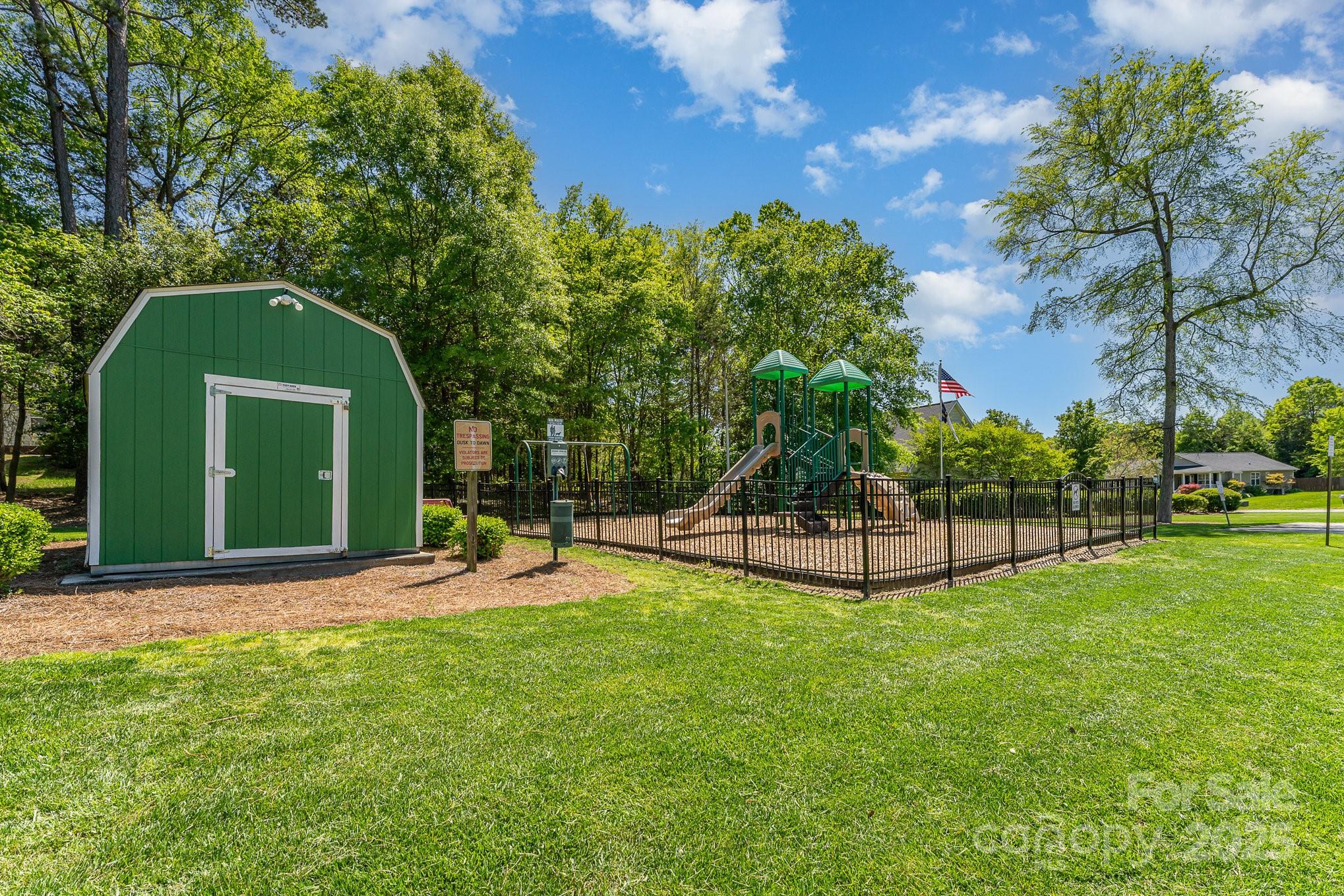 1076 Braxton Drive Concord, NC 28025 - Photo 20 of 20 a view of a backyard with a garden and entertaining space