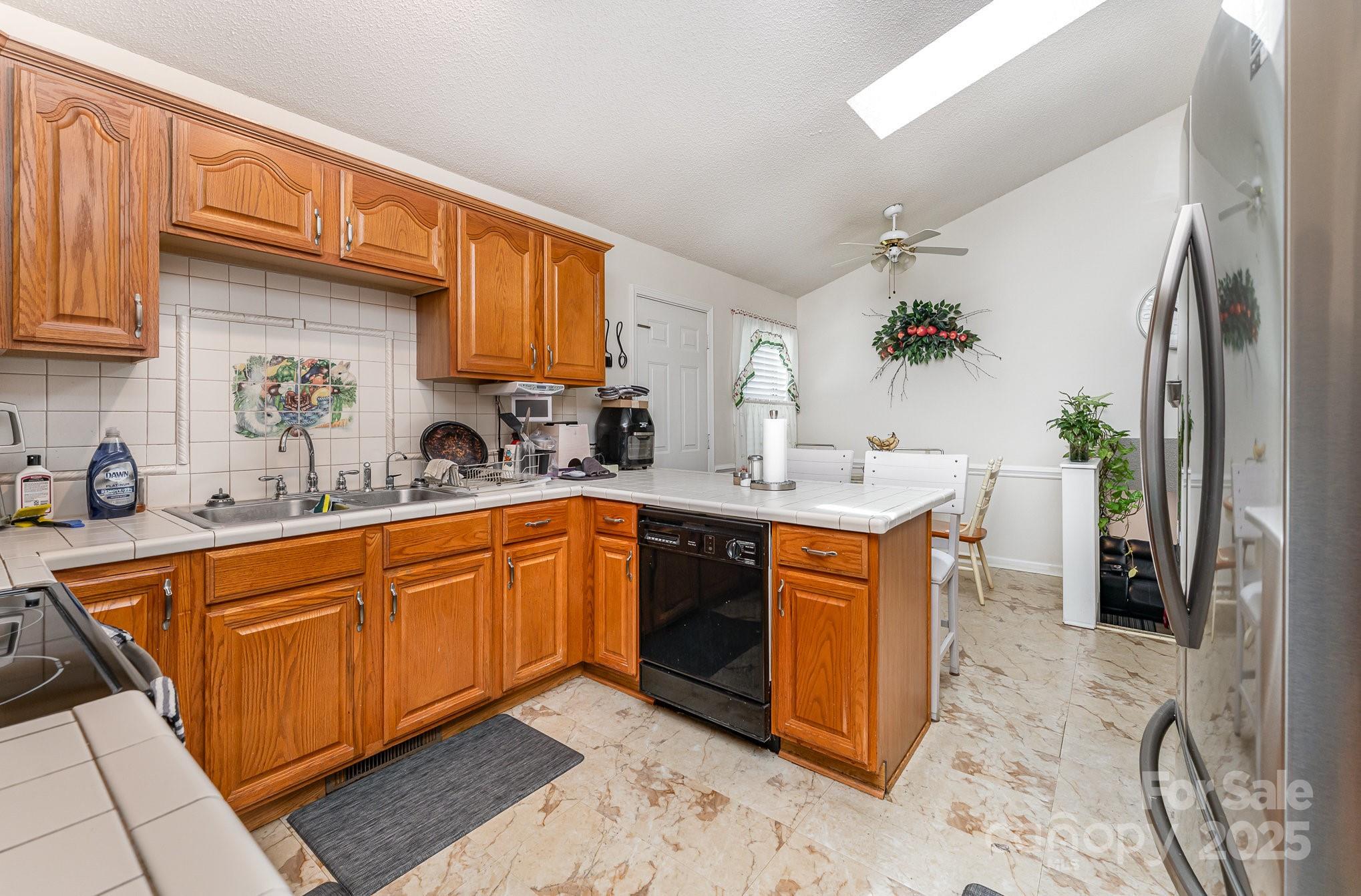 1076 Braxton Drive Concord, NC 28025 - Photo 7 of 20 a kitchen with stainless steel appliances granite countertop a sink stove and refrigerator