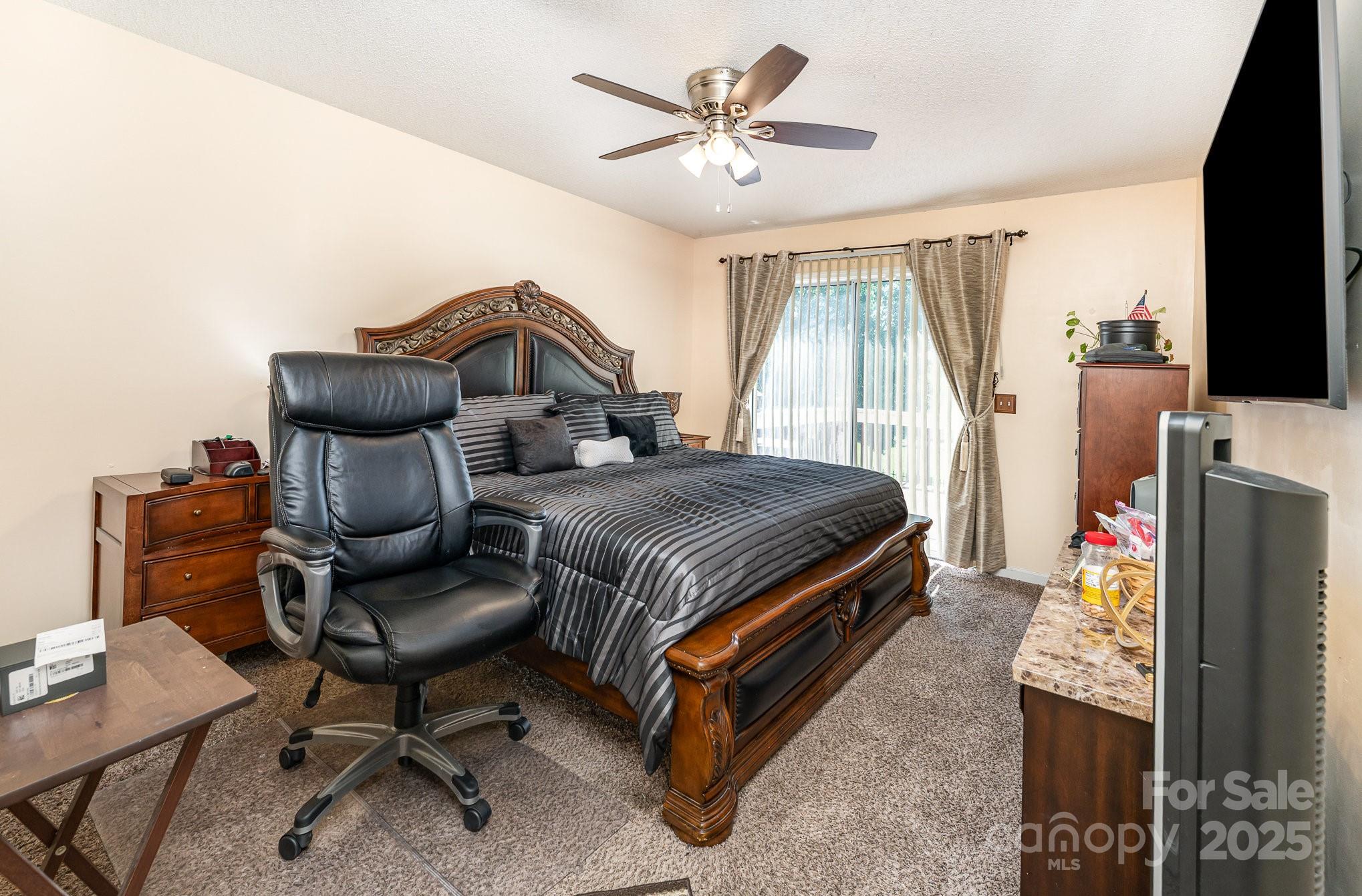 1076 Braxton Drive Concord, NC 28025 - Photo 10 of 20 a bedroom with a bed and a chandelier