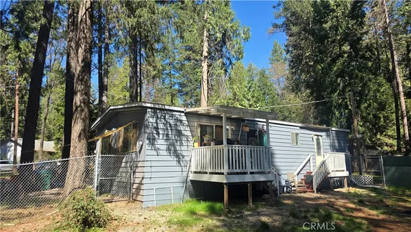 a view of house with a yard