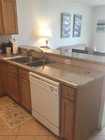 a kitchen with stainless steel appliances granite countertop a sink and a white cabinets