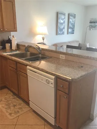 a kitchen with stainless steel appliances granite countertop a sink and a white cabinets