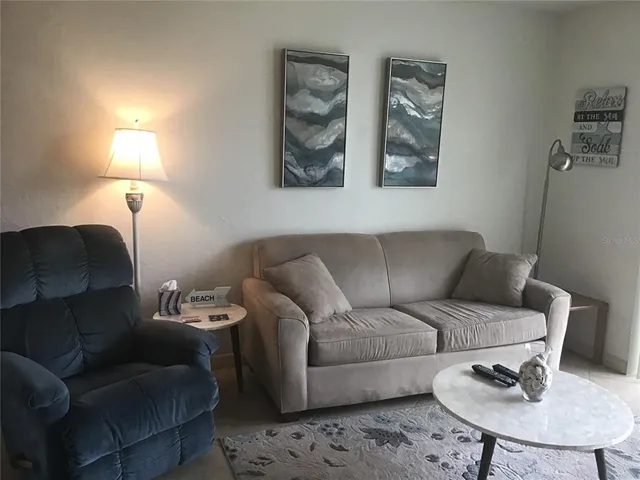 a living room with furniture and a lamp