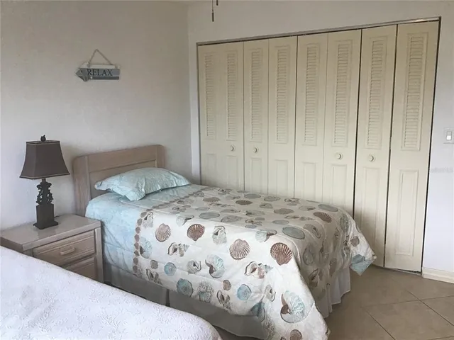 a bedroom with a bed and a mirror