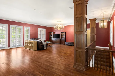 a view of a living room hardwood floor and a kitchen