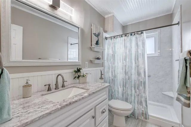 a bathroom with a granite countertop toilet sink and shower