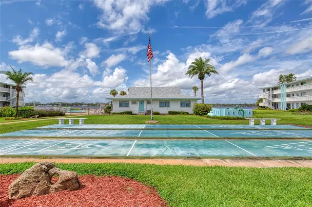 a view of yard with swimming pool and green space