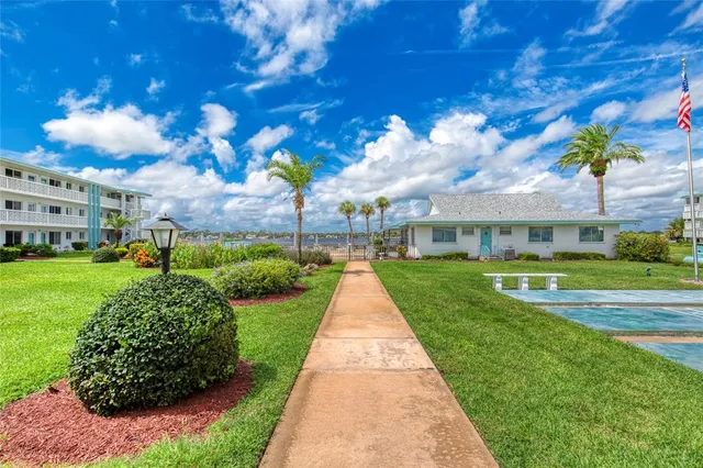 a view of yard with swimming pool and green space