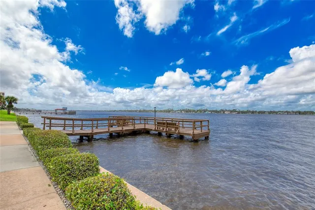 a view of a kitchen with furniture and wooden floor