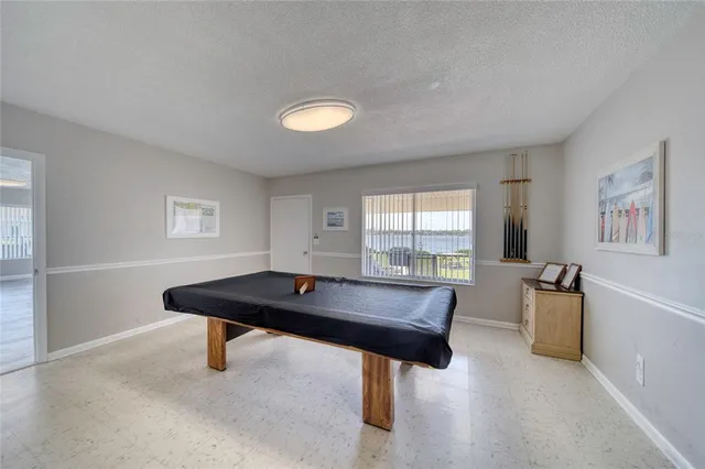 a kitchen with refrigerator and cabinets