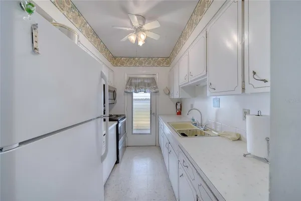 a view of a house with swimming pool and a yard