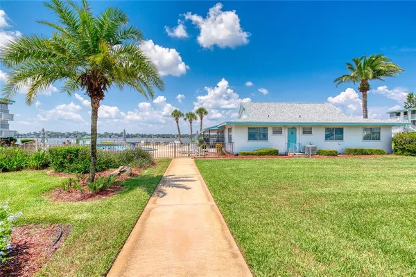 a view of a patio with table and chairs potted plants with wooden fence