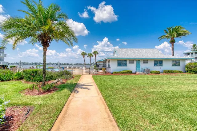 a view of a patio with table and chairs potted plants with wooden fence