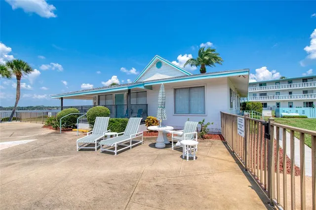 a view of a patio with a chairs and table in a patio