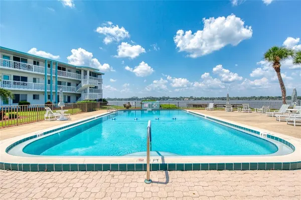 a view of a swimming pool with a table and chairs
