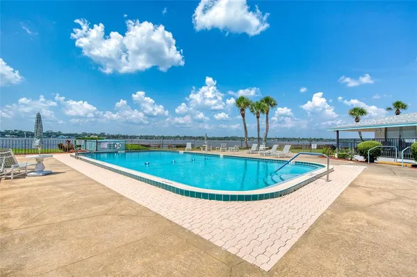 a view of a swimming pool with a table and chairs