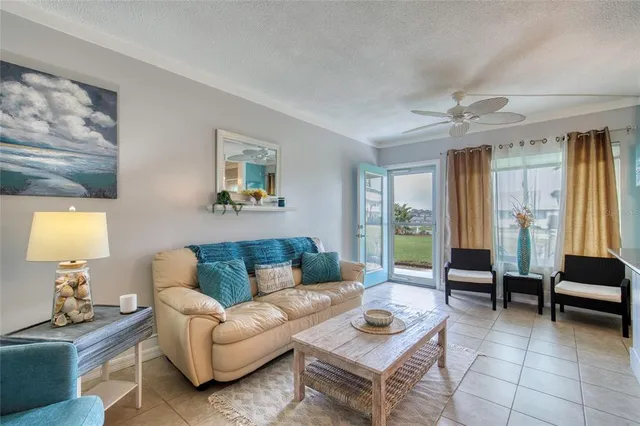 a large living room with stainless steel appliances kitchen island granite countertop furniture and a living room