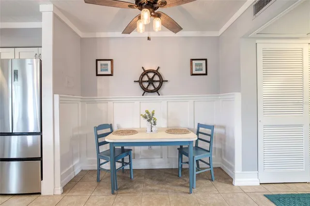 a kitchen with granite countertop a sink stainless steel appliances and windows