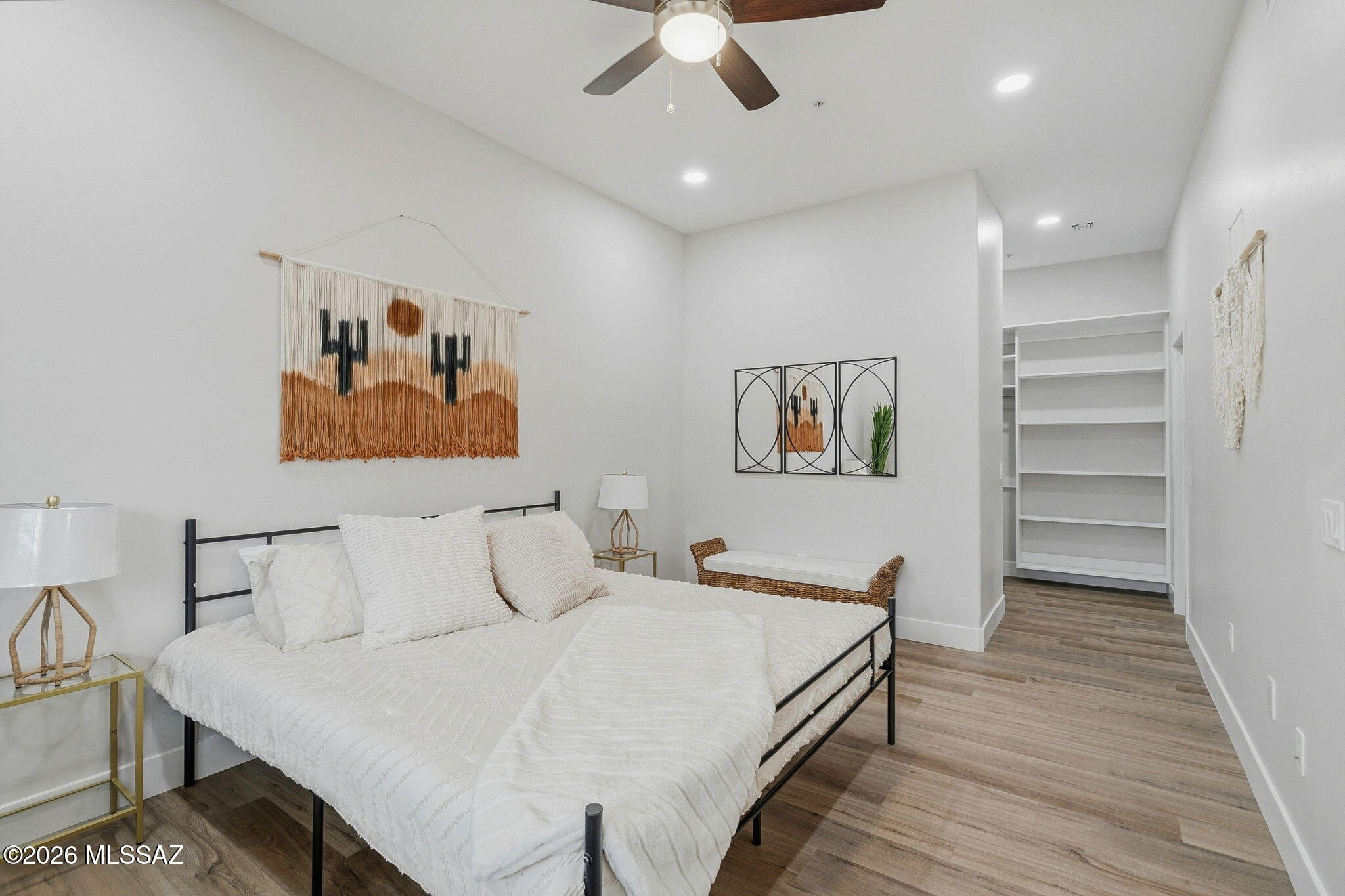 2020 East River Road, Unit 201 Tucson, AZ 85718 - Photo 6 of 10 a bedroom with a bed and a chandelier