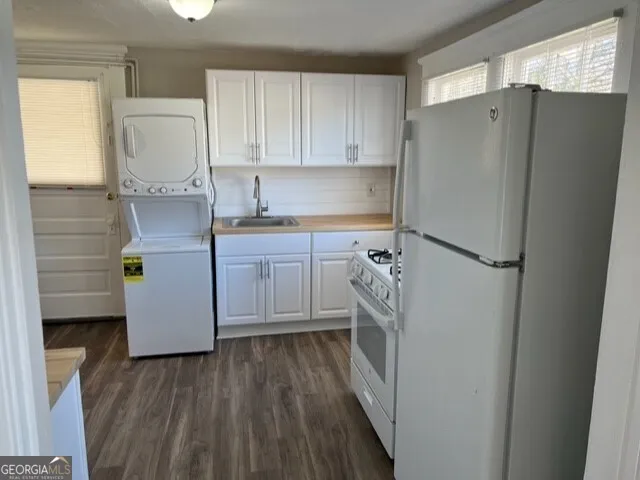 a kitchen with a refrigerator a sink and cabinets