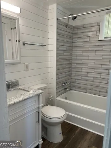 a bathroom with a granite countertop toilet sink and shower