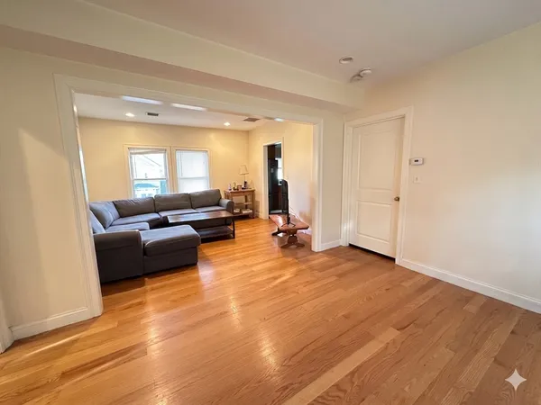 a living room with furniture and a large mirror