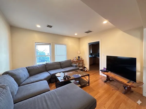 a living room with furniture window and a flat screen tv