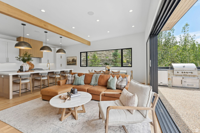 1400 Weber Wild Road Oakley, UT 84055 - Photo 18 of 55 Open-concept living area featuring wood-finish flooring, recessed lighting, and exposed ceiling beams
