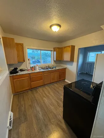 a kitchen with stainless steel appliances a stove a sink a refrigerator and a cabinets