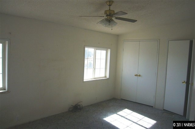 5990 Sarah Road Fallon, NV 89406 - Photo 7 of 12 an empty room with a window and a fan