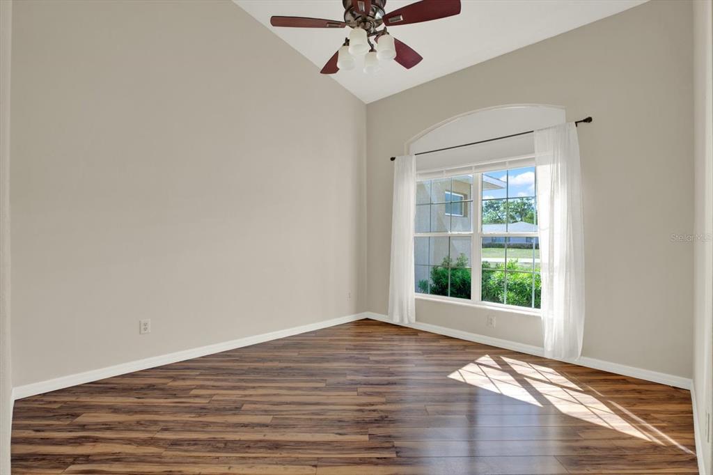 4400 Dior Road Spring Hill, FL 34609 - Photo 7 of 37 a view of a big room with wooden floor and windows