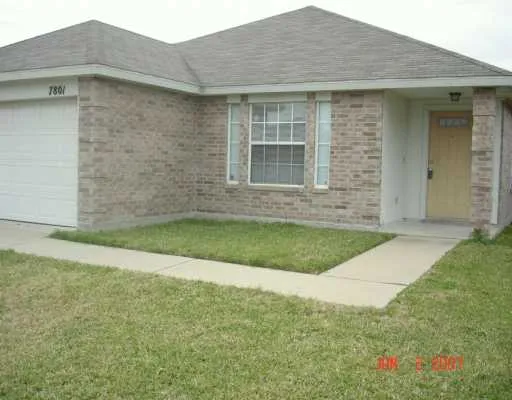 a brick house with a small yard