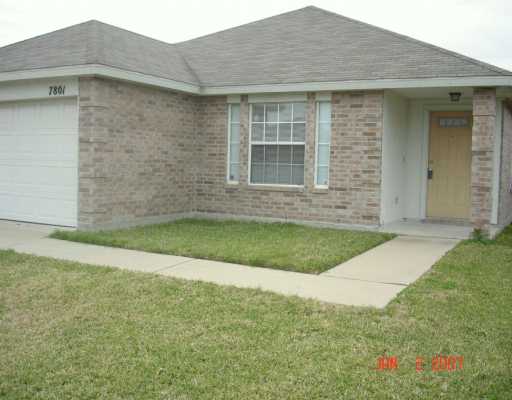 a brick house with a small yard