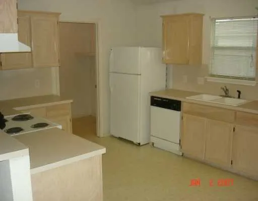 a utility room with cabinets washer and dryer