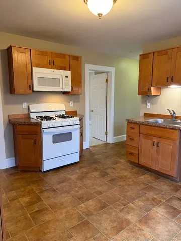 a kitchen with a stove top oven cabinets and stainless steel appliances