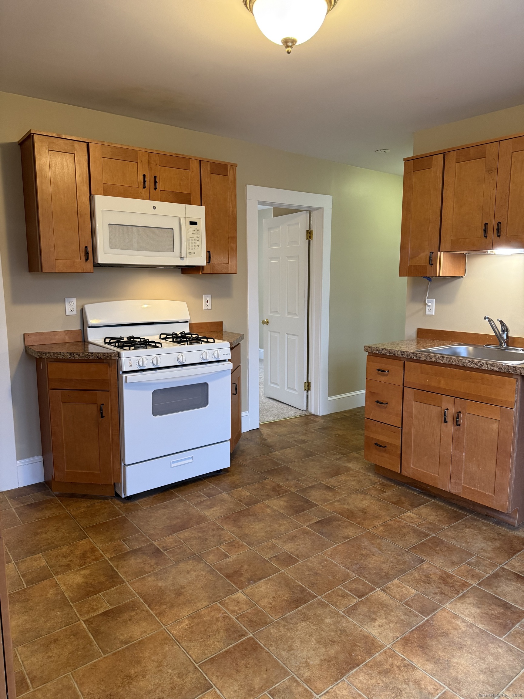 a kitchen with a stove top oven cabinets and stainless steel appliances